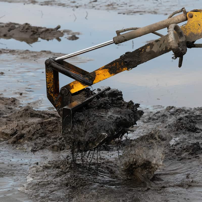 Dredging sediment with heavy equipment